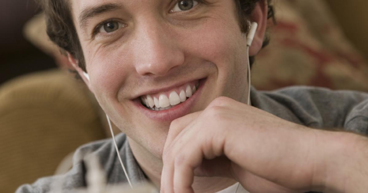 Young man with iphone and earpads